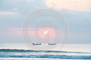 Landscape of small fishing boats of Vietnamese fishermen fishing at dawn in the sea