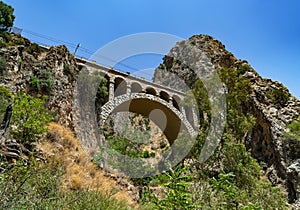 Landscape of a small stone bridge between two mountains