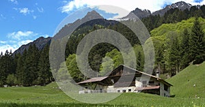 Landscape with snow-capped mountains and huts