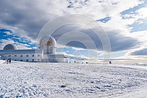 Landscape with snow, panorama of the tower in Serra da Estrela Natural Park with silhouettes of people, Manteigas PORTUGAL
