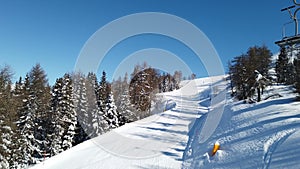 Landscape snow slope with chair lift pov dolomites