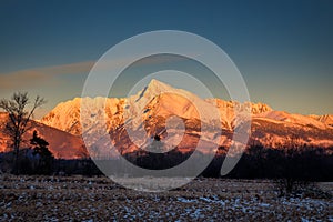 Landscape of snowy mountain peak at sunset