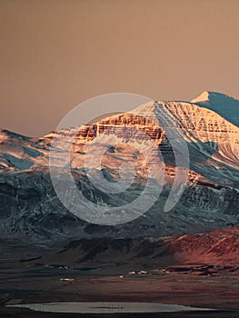 Landscape with snowy mountain slopes at sunset, Iceland
