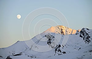 Landscape of snowy mountains, with the moon