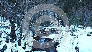 Landscape of snowy mountains and a waterfall near Cauterets with hikers in the background