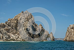 Landscape south view on El Arco behind tall boulder, Cabo San Lucas, Mexico photo