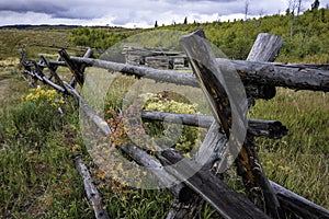 Landscape of a split rail fence leading into the distance.