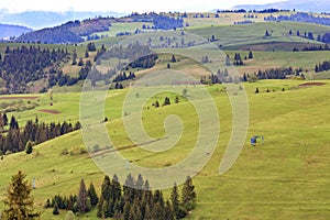 Landscape of the spring Carpathian mountains with blue masts of a mountain cable lift leading to the top of the mountain