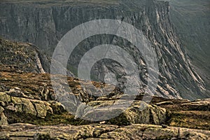 Landscape with steep cliffs in the fjord passing by Trolltunga