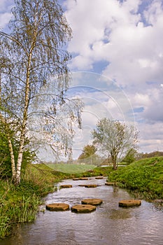 Landscape with steppjng stones in the river Regge in the Netherlands photo