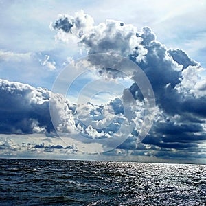 Landscape: storm clouds at dawn over the sea.