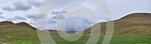 Landscape stormy panorama view from the border of Utah and Idaho from Interstate 84, I-84, view of rural farming with sheep and co