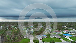 Landscape of stormy sky over North Port town with tarp covered roofs after hurricane Ean swept through Florida with dark