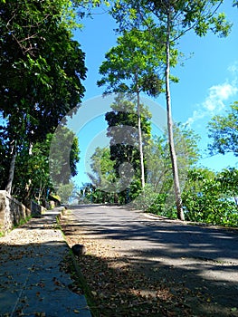 Landscape of Suban Air Panas Park, with road, sunlight and background blue sky photo