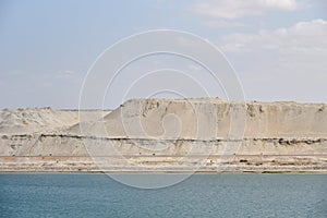 Landscape of Suez Canal, view from transiting cargo ship.