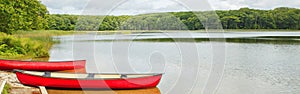 Landscape summer scene at Canadian Ontario Kettles lake in Midland area. Canada forest park nature with red kayaks canoe boats