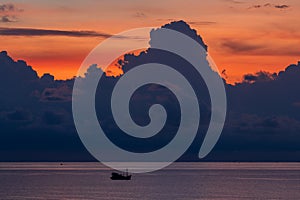 Landscape sunrise on the island of Phu Quoc, Vietnam. Morning sky, storm clouds, fishing boat and sea water