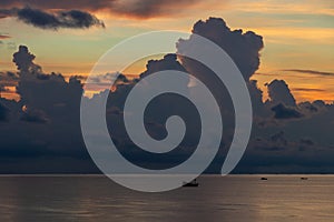 Landscape sunrise on the island of Phu Quoc, Vietnam. Morning sky, storm clouds, fishing boat and sea water