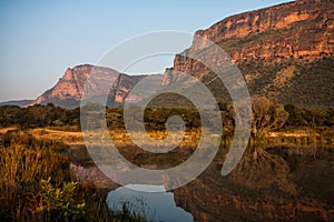 Landscape at sunrise with mountains and a lake  in Entabeni Game Reserve