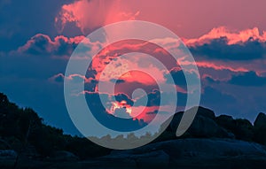 Landscape of sunset with dramatic sky and rock island and sea.