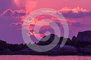 Landscape of sunset with dramatic sky and rock island and sea.