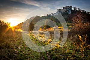 Landscape at sunset with ruin of medieval castle.