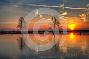 Landscape sunset or sundown river Narew Poland Europe spring time meadows under water