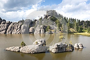 Landscape of the Sylvan Lake surrounded by rocks and greenery in South Dakota, the US