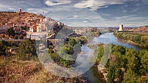 Landscape the town of Asco with its nuclear power plant in the background and the Ebro river that cools it, Tarragona, Spain