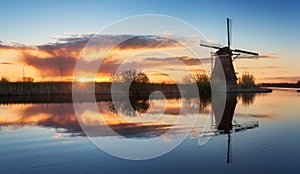 Landscape with traditional dutch windmills at colorful sunrise