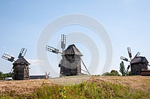 Landscape with traditional Ukrainian windmills houses in countryside village. Windmill mill at rural outdoor. Wind mill. Windmill