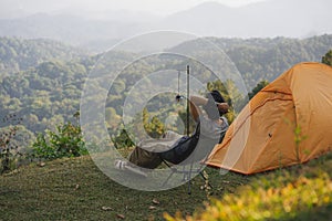 landscape and travel with solo freelancer man relax and see sunset and twilight sky with layer of mountain