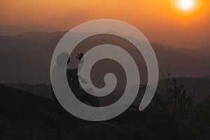 landscape and travel with solo freelancer man relax at top of mountain and sunset with layer of mountain