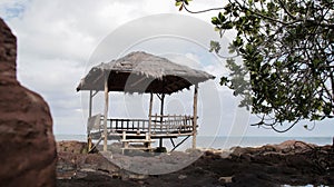 Landscape tropical asian beach hut natural wooden handmade and thatch roof on the rocky shore