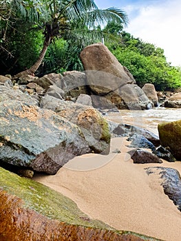 Landscape of tropical beach in the lagoon with big rocks and cliffs