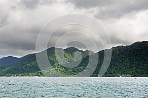Landscape with tropical sea, monsoon storm heavy clouds and tropical Koh Chang island on horizon in Thailand