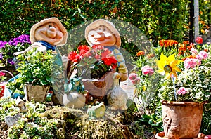 Landscape with two funny garden gnomes among colorful flowerpots in the Spreewald Biosphere Reserve, Brandenburg, near Berlin, Ge