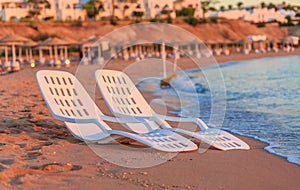 Landscape of Two Lonely beachchairs near sea and beautiful sunrise