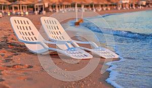 Landscape of Two Lonely beachchairs near sea and beautiful sunrise