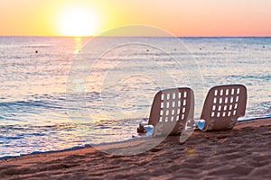 Landscape of Two Lonely beachchairs near sea and beautiful sunrise