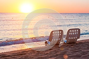 Landscape of Two Lonely beachchairs near sea and beautiful sunrise photo