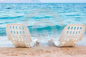 Landscape of Two Lonely beachchairs near the sea photo
