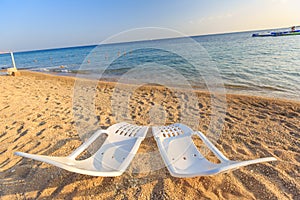 Landscape of Two Lonely beachchairs on the sand near sea