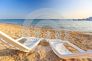 Landscape of Two Lonely beachchairs on the sand near sea