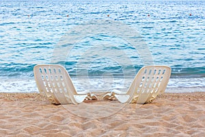 Landscape of Two Lonely beachchairs on the sand near sea