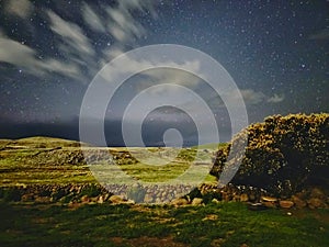 LANDSCAPE UNDER THE MOONLIGHT WITH CLOUDS AND MANY STARS photo