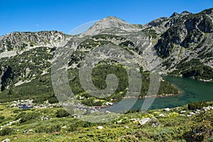 Landscape with Upper Vasilashko lake and green hills of Pirin Mountain, Bulgaria