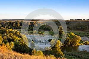 Landscape of the valley, the river, trees, the field, and the sk