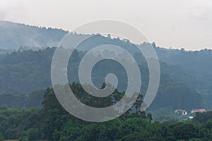 Landscape of a valley with wooded hills after a summer storm, horizonta