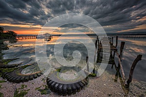 Landscape of Varna lake at sunset with fisherman house and piers